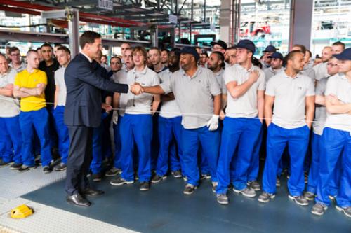 Prime Minister Mark Rutte shakes hands with a employee of VDL Nedcar